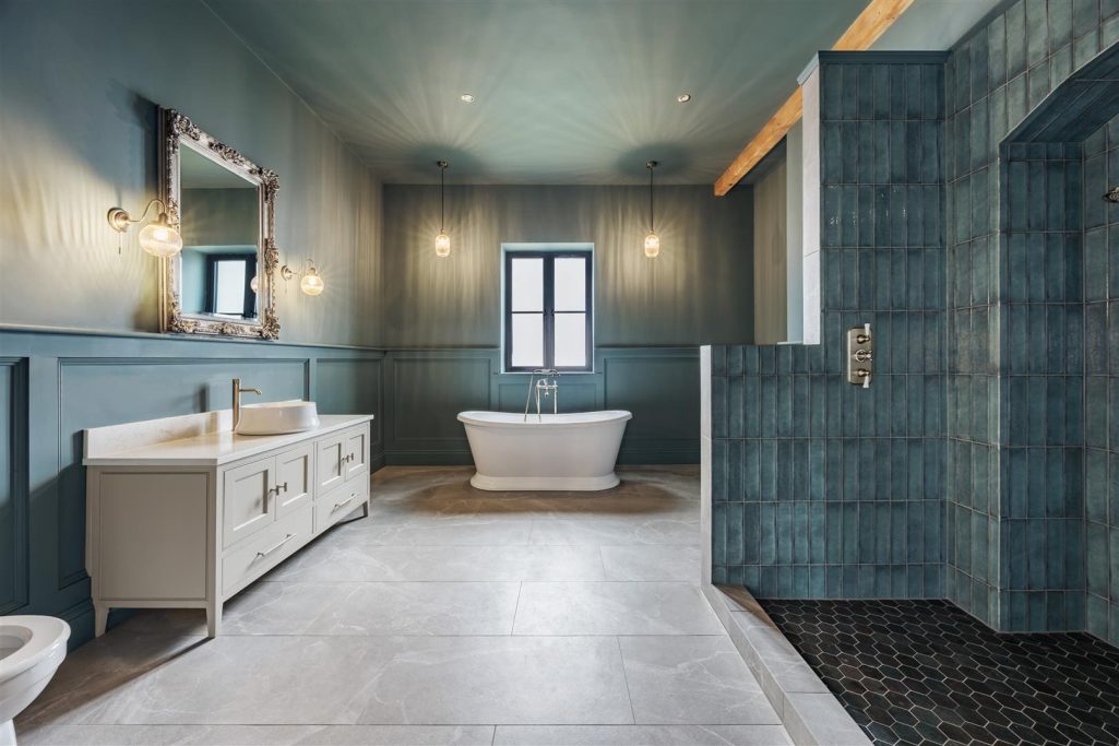 Bathroom Renovation Modern bathroom with a freestanding bathtub, double vanity, and elegant wall decor.