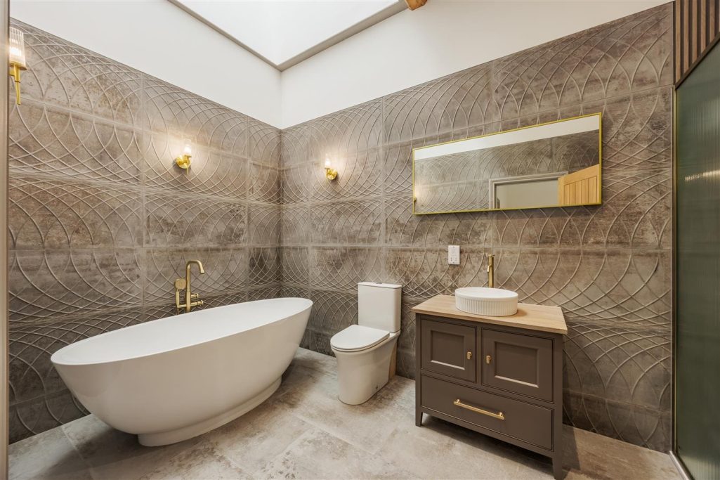 Bathroom Renovation Modern bathroom with a freestanding tub, wooden vanity, and elegant fixtures.